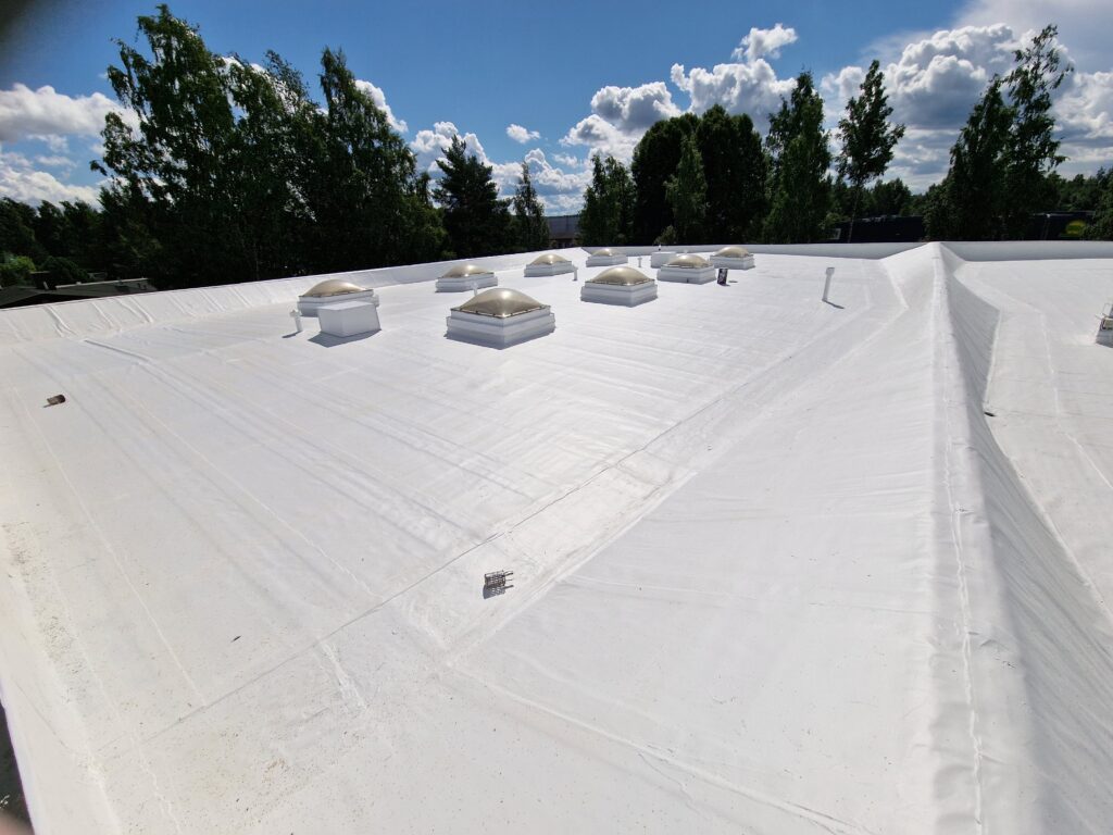 Commercial flat roof finished in white CoolRoof coating